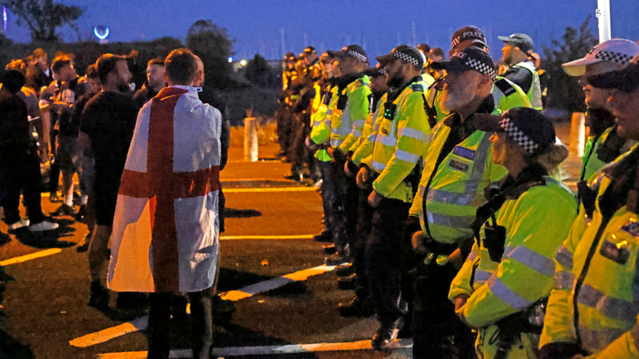 Protesters scuffle with police as migrants brought ashore on south coast